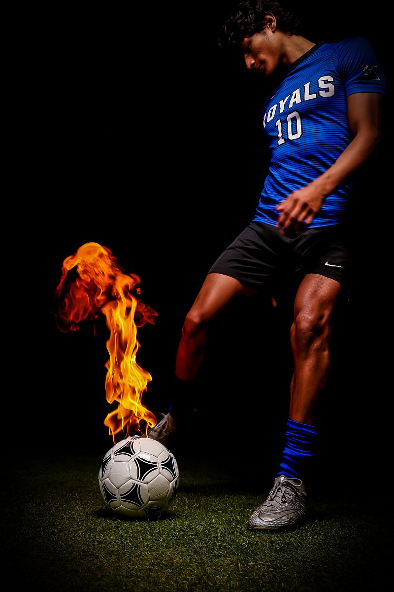 male soccer specialty portrait with fire ball