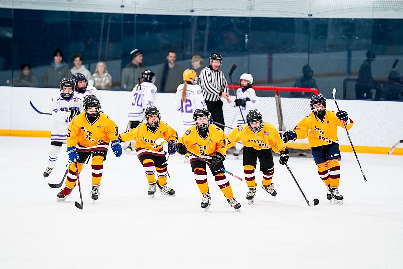 hockey team action photographer five players skating in yellow uniforms