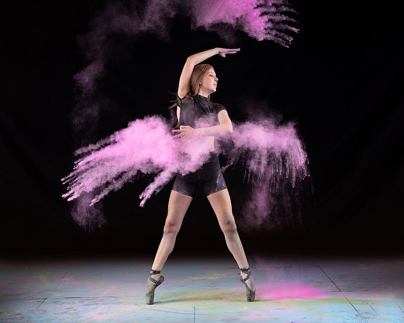 ballerina throws pink chalk in media day photoshoot